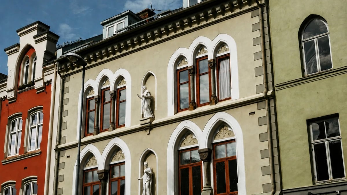 The historic Villa Nord facade on Dronningens gate in Trondheim, with pointed arched windows.
